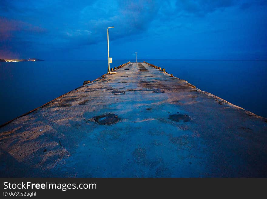 Old pier on the shore. Going to the sea. Marine landscape