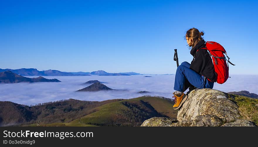 Successful woman backpacker enjoy the view on mountain peak