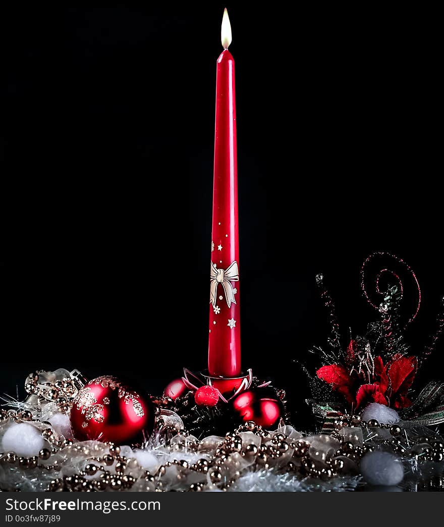 Candle and Christmas composition on a black background.photo with copy space