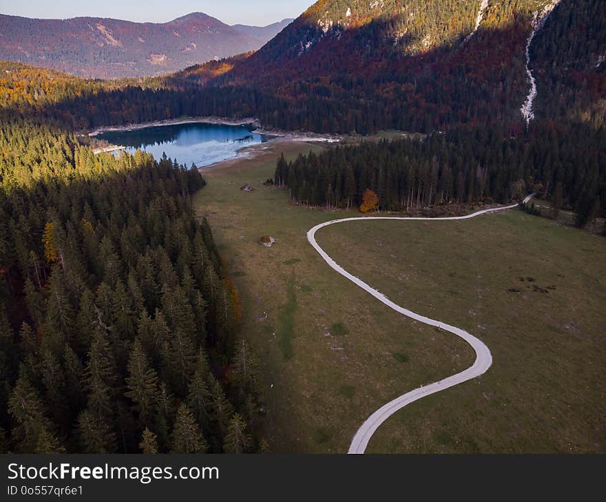 Aerial view over road leading into Fusine Lakes,Italy