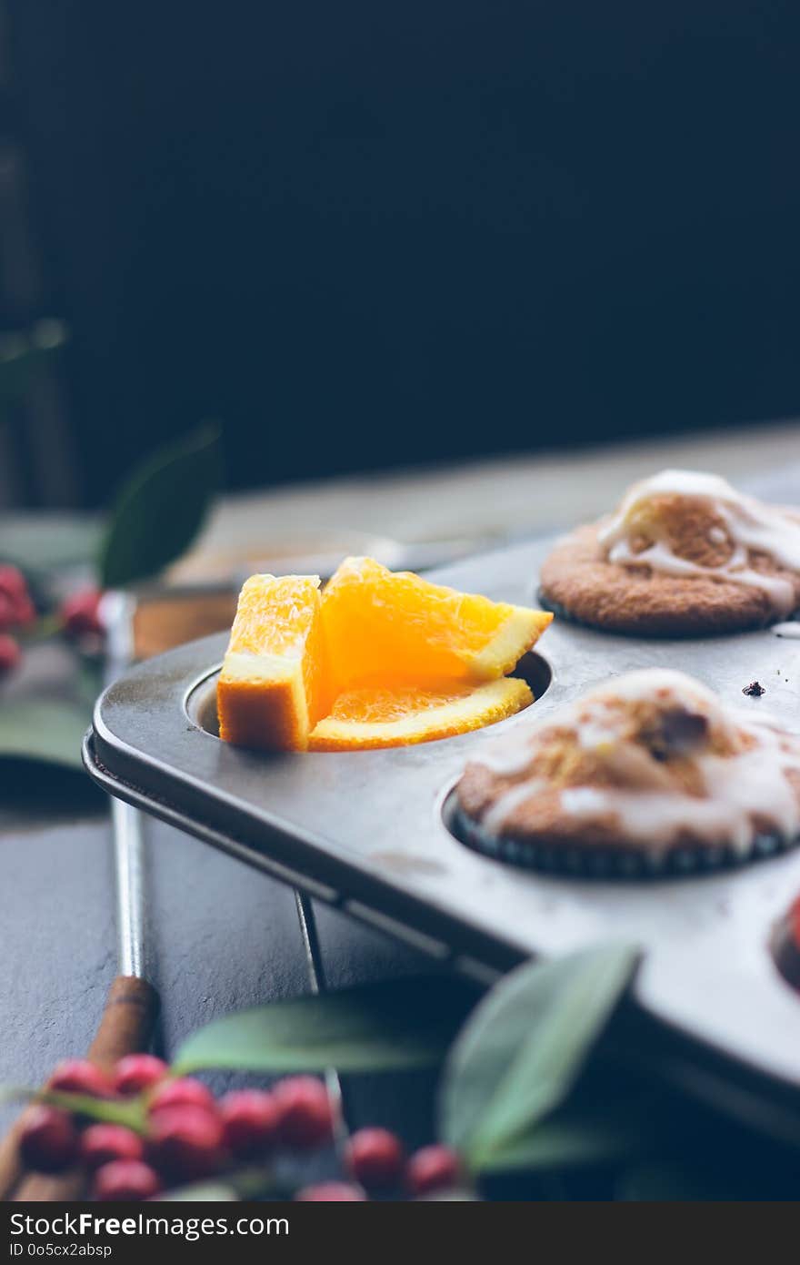 Cherry orange muffins in muffin baking pan; food background