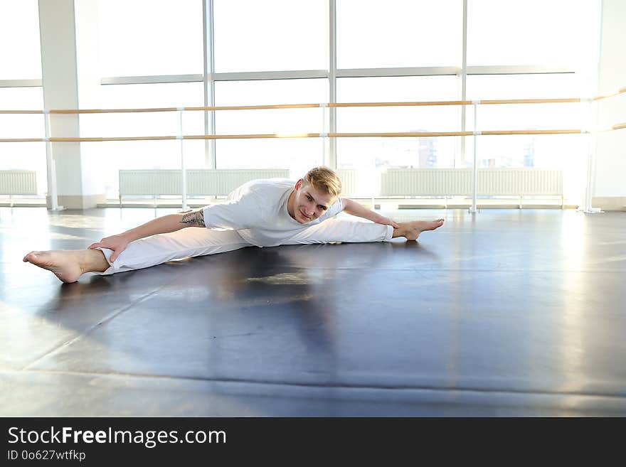 Young Man Doing Morning Exercises With Towel On Neck.