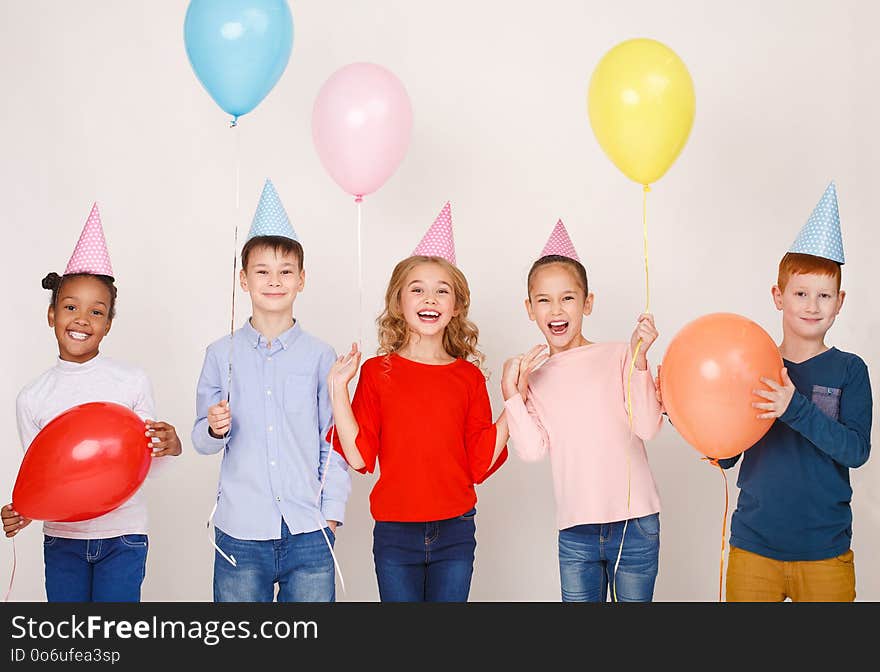 Happy Children With Colourful Balloons Over Wall