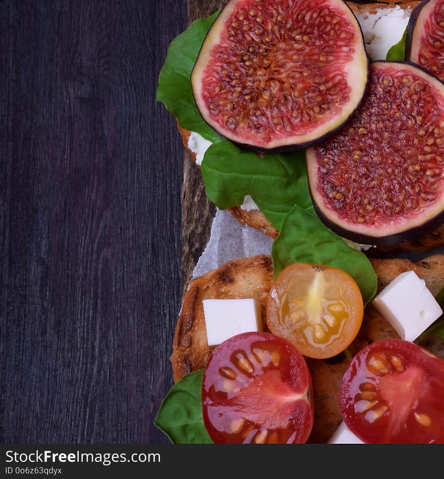 Bruschettas with figs, cherry tomatoes, cheese and honey. Bruschettas with figs, cherry tomatoes, cheese and honey