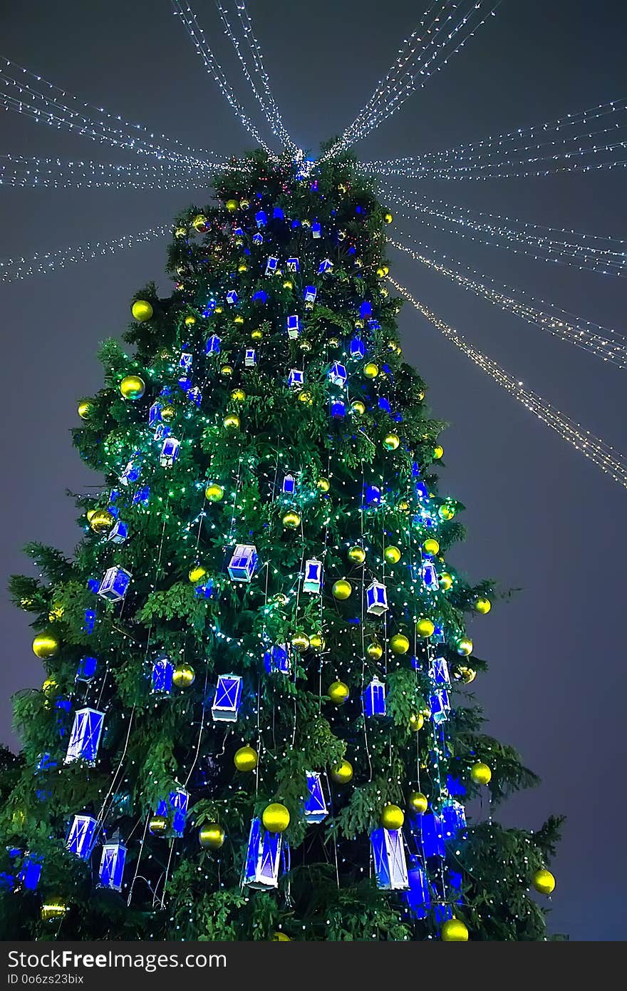 Christmas tree decorated with lanterns outdoors at night. Christmas tree decorated with lanterns outdoors at night