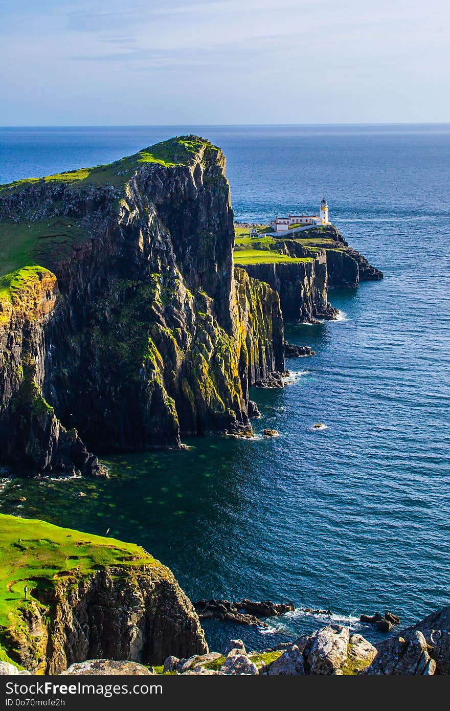 Panoramic scenic landscape view of landmark Neist Point Lighthouse on Isle Of Skye in Scotland, United Kingdom. Tourist popular destination/attraction in summer. Panoramic scenic landscape view of landmark Neist Point Lighthouse on Isle Of Skye in Scotland, United Kingdom. Tourist popular destination/attraction in summer.