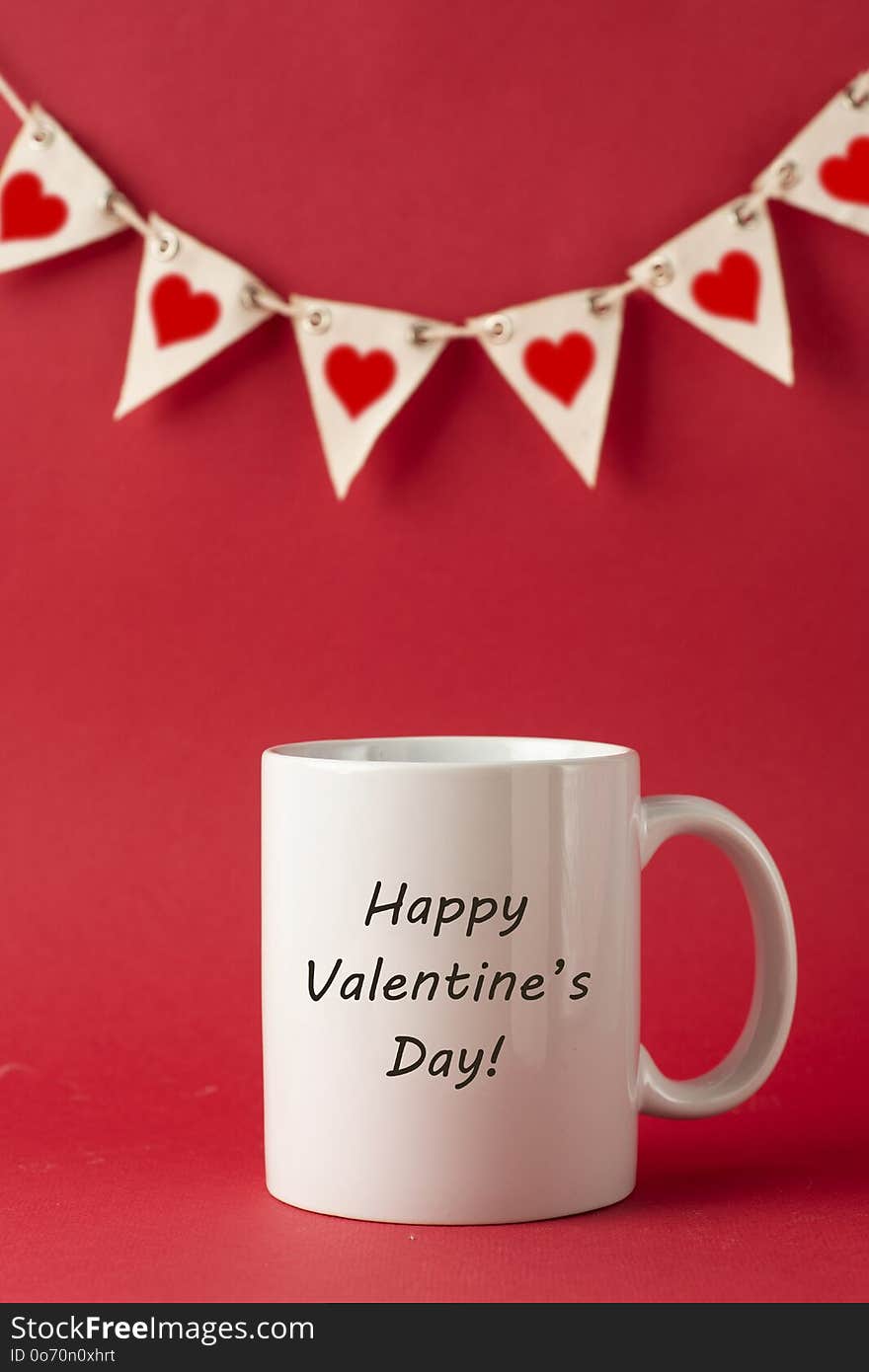 Cup with Happy Valentine&#x27;s Day inscription, words for Valentines Day on red background. Love celebration