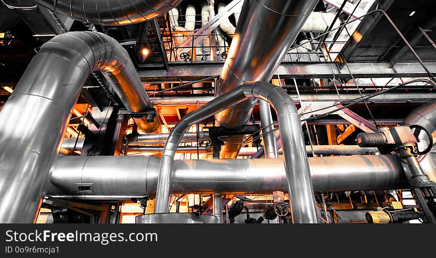 Equipment, cables and piping as found inside of a industrial power plant. Equipment, cables and piping as found inside of a industrial power plant