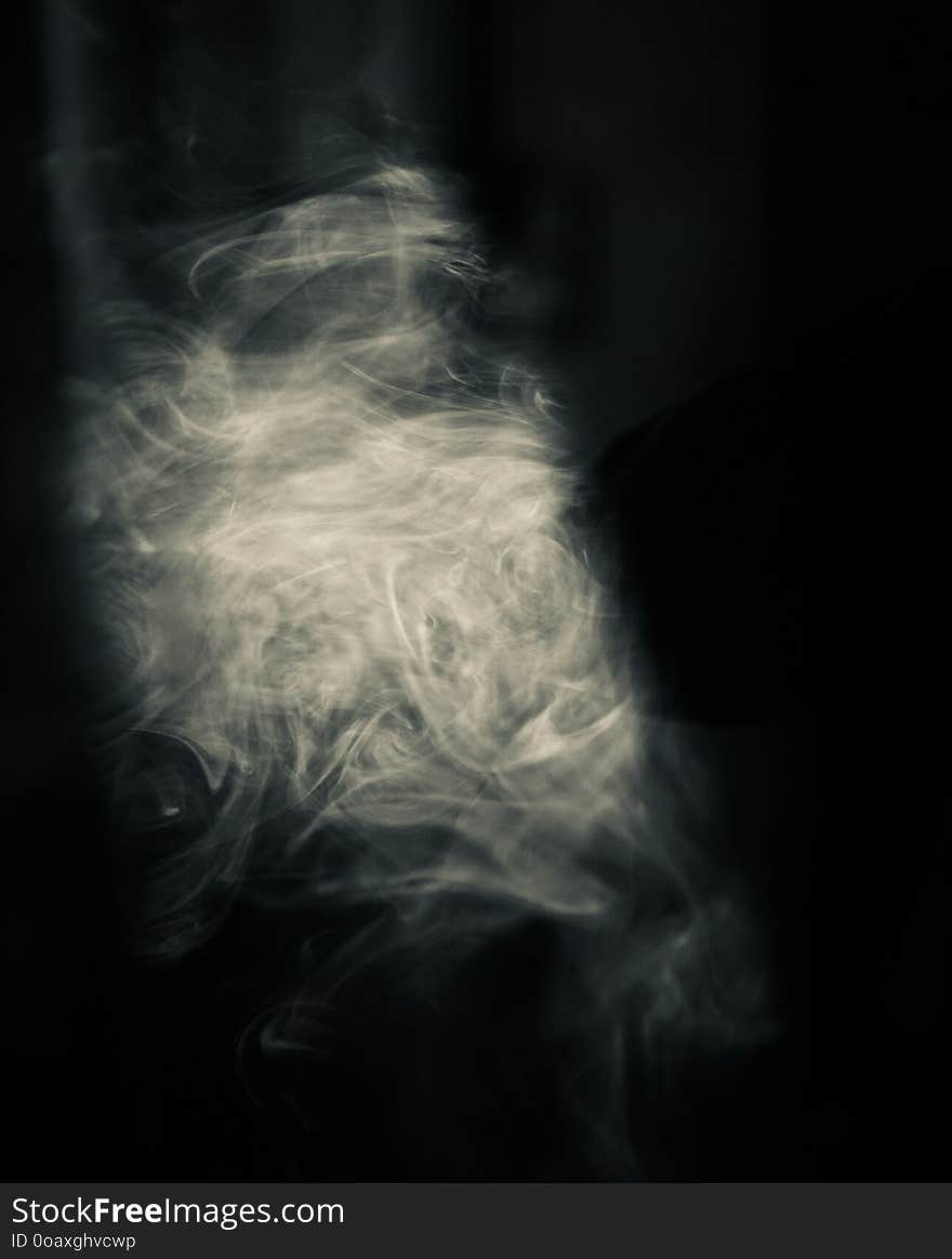 White cigarette smoke with black background photo