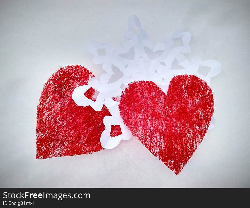 red cut hearts with paper white snowflake. red cut hearts with paper white snowflake