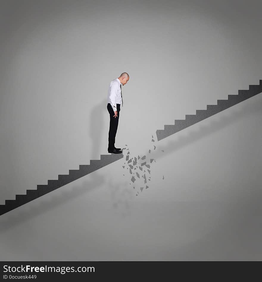 Businessman Looking Down On Broken Stairs