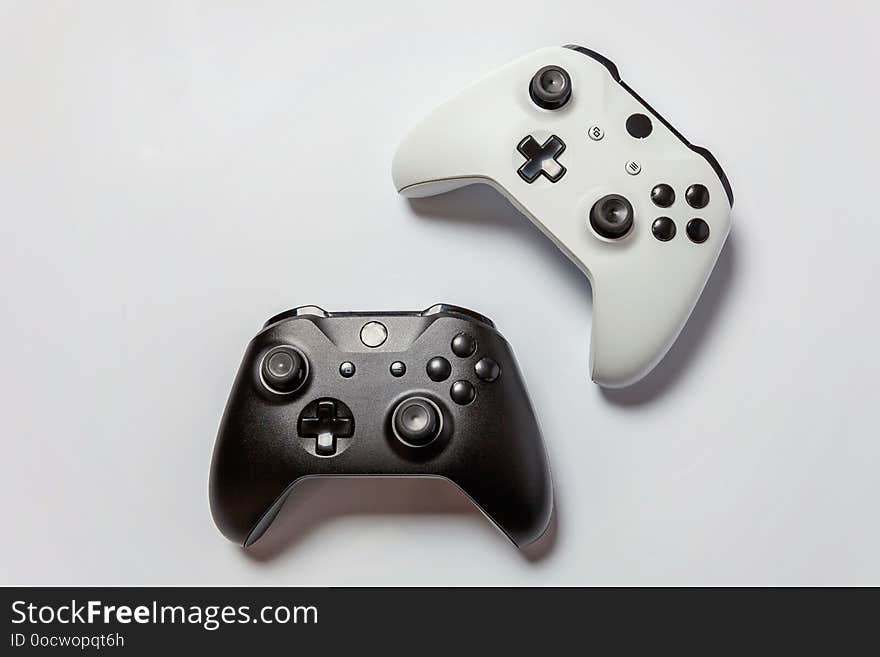 White and black two joystick gamepad, game console isolated on white background. Computer gaming technology play competition videogame control confrontation concept. Cyberspace symbol. White and black two joystick gamepad, game console isolated on white background. Computer gaming technology play competition videogame control confrontation concept. Cyberspace symbol