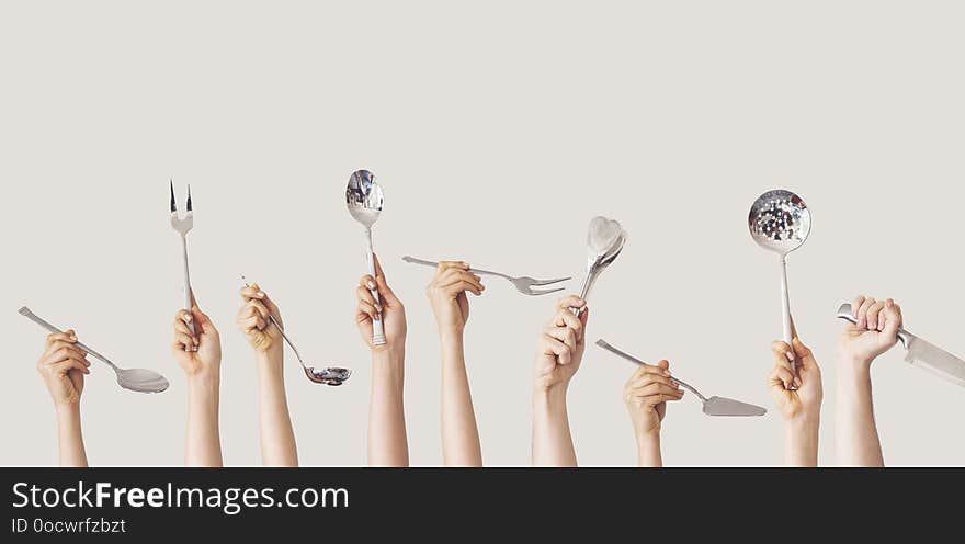Hands holding kitchen equipment on isolated background hands and hold