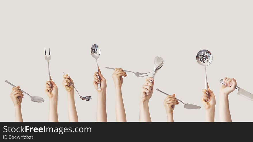 Hands holding kitchen equipment on isolated background