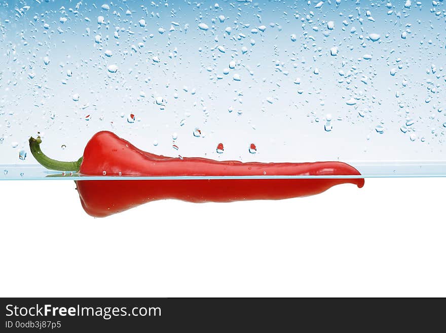 Single Red pepper in water splash