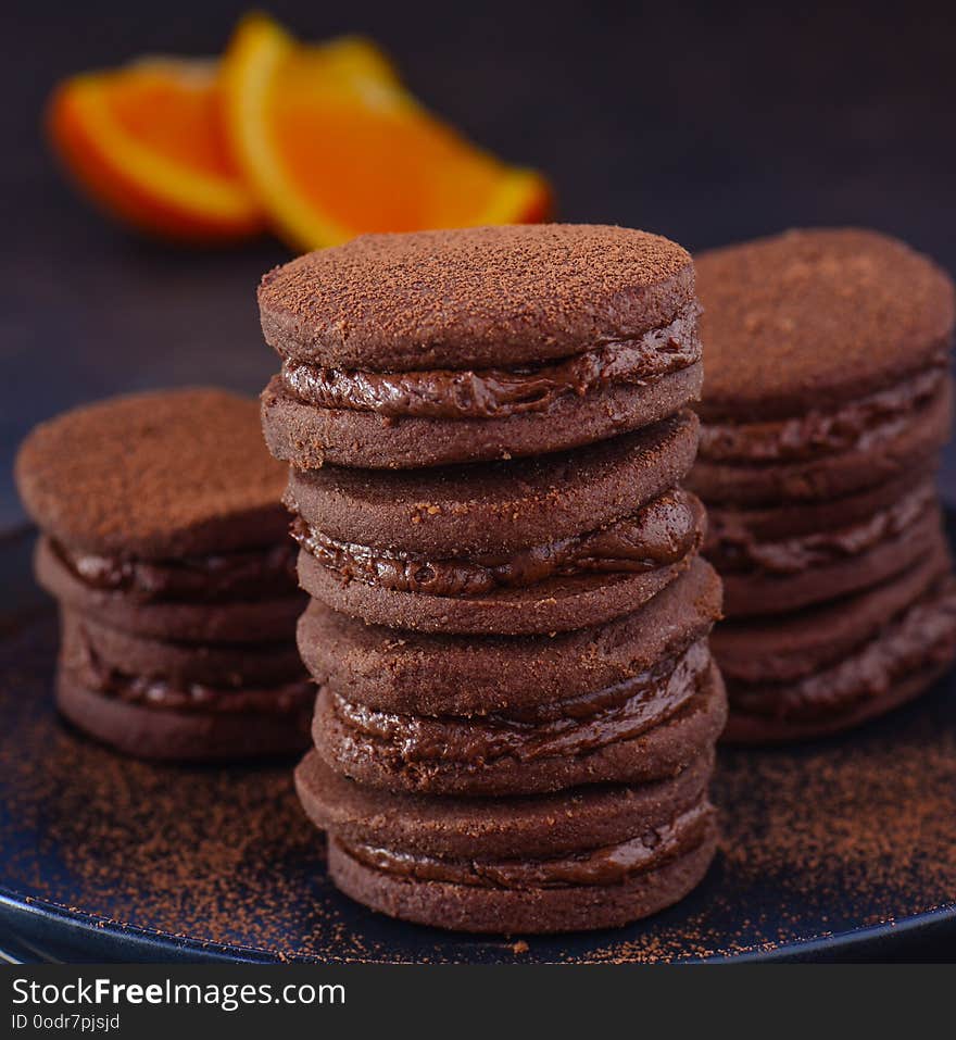 Chocolate cream macaroons or biscuits baked with chocolate orange cream. Chocolate cream macaroons or biscuits baked with chocolate orange cream