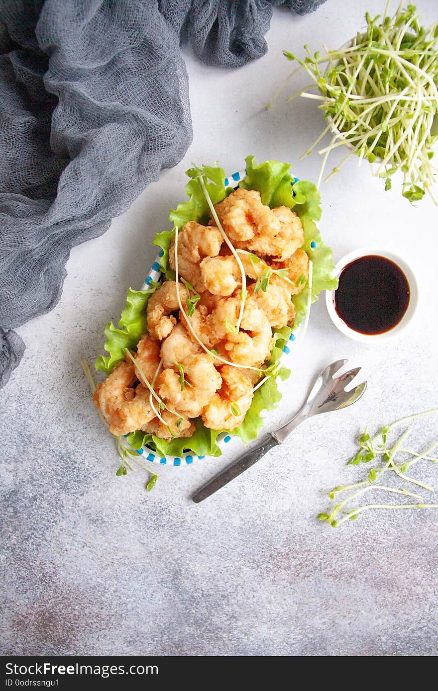 Grilled breaded king prawns on a fresh green salad leaf. Grilled breaded king prawns on a fresh green salad leaf