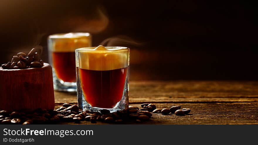 Cappuccino, espresso and coffee beans on wood