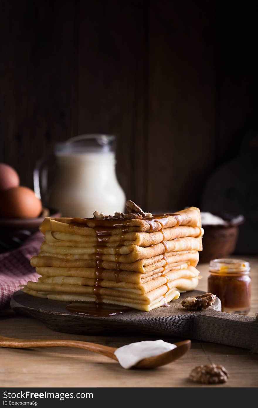 Tasty crepes with Raspberry jam. French crepes, russian or ukrainian blini or blintzes with fresh Raspberry on blue plate. Maslenitsa holiday food.