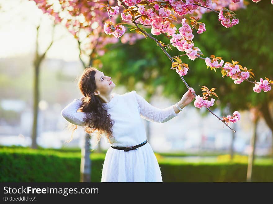 Woman enjoying cherry blossom season in Paris, France