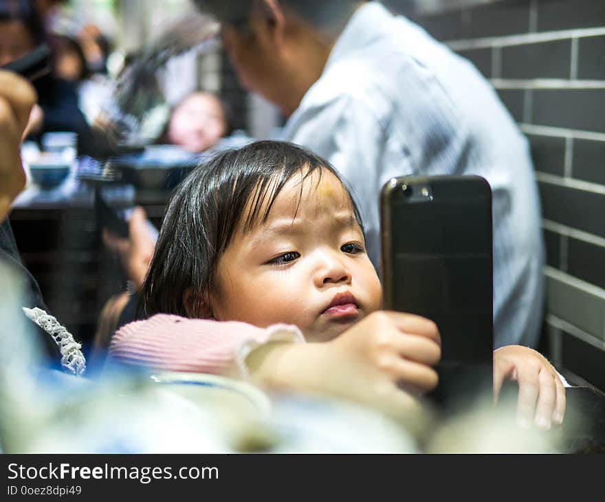 Little Kid Is Playing With Mobile Phone