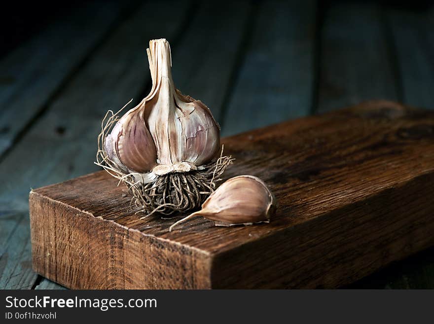 Raw garlic on wooden background, rustic style.