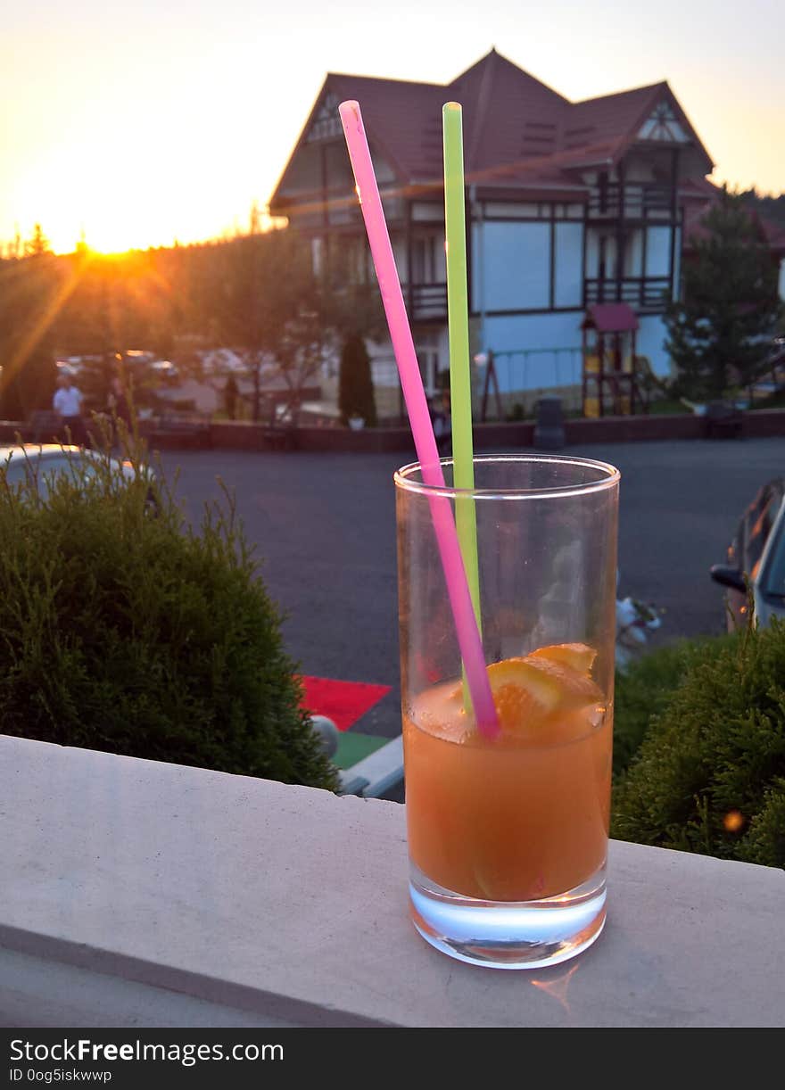 Cocktail With Lemon At Sunset