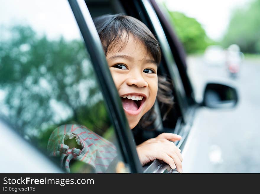 Little girl looking out to the windows open with smile