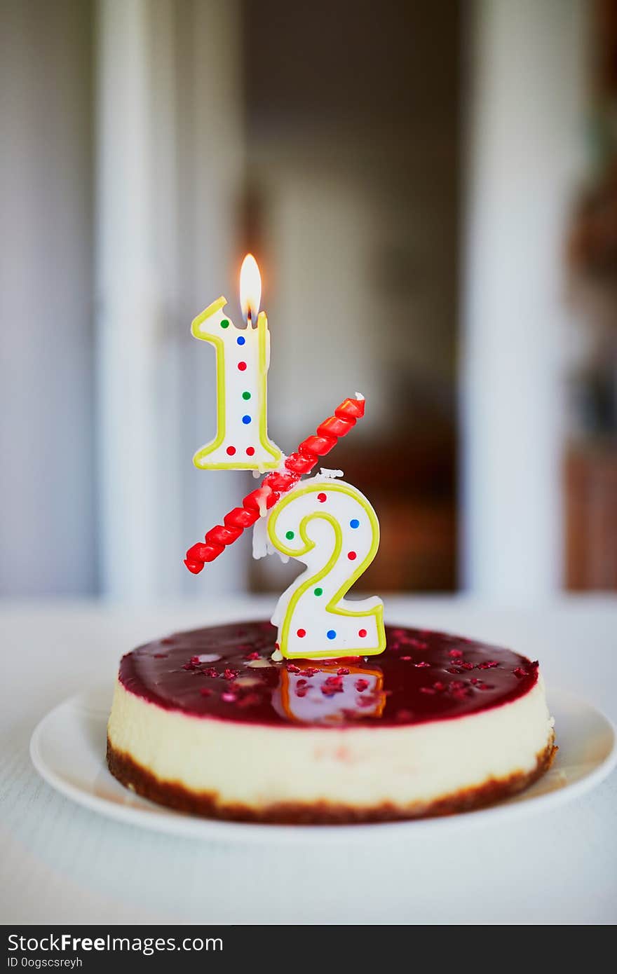 Birthday cake with candle on it. Creative way to celebrate six month of a baby. Anniversary candle in form of a decimal meaning half of a year