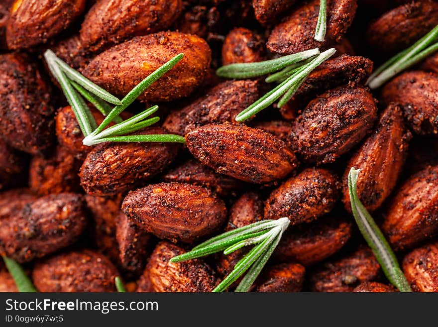 Concept of Spanish cuisine. Snack to wine or beer. Spicy almonds with pecias, rosemary, smoked paprkika, chili pepper, olive oil and salt. The dish is served on a parchment plate. background image