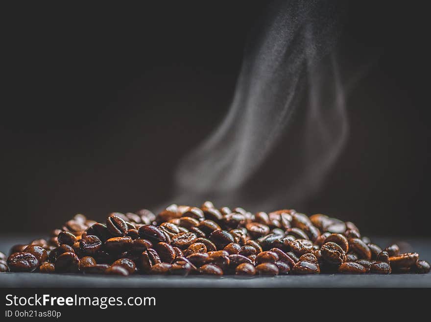 Hot coffee beans and smoke, macro photography