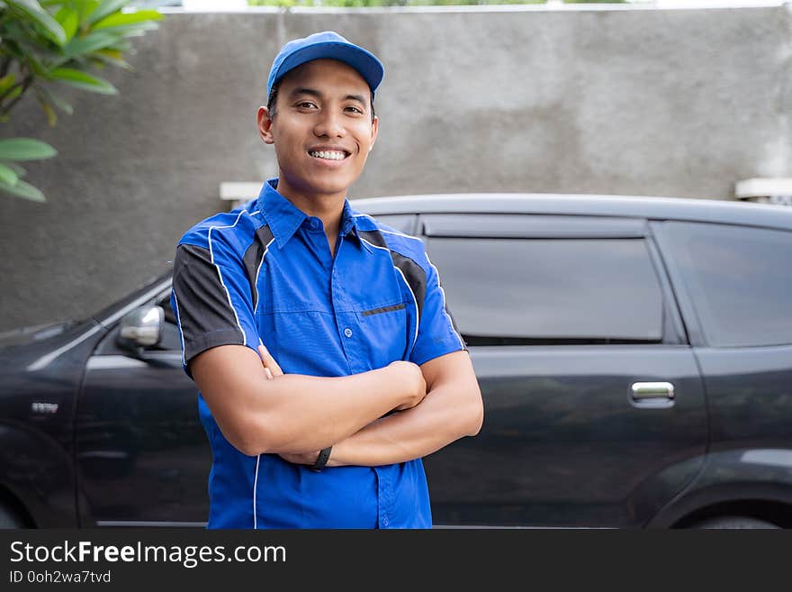 Asian Car Mechanic Smiling To Camera