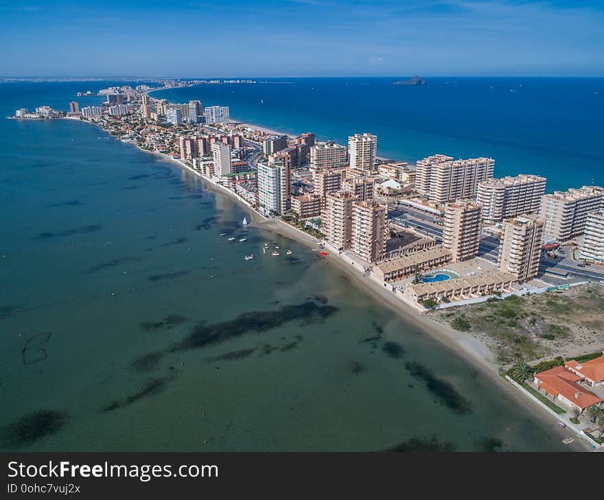 Aerial photo of tall buildings and the beach on a natural spit of La Manga between the Mediterranean and the Mar Menor, Cartagena, Costa Blanca, Spain. 2