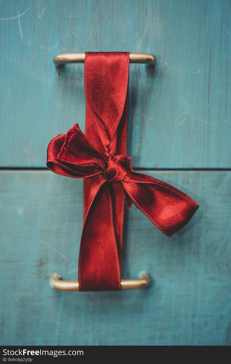 Red bow on blue drawers close up