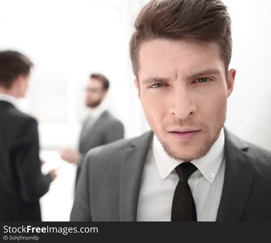 Close up.portrait of a serious young businessman on a blurred background