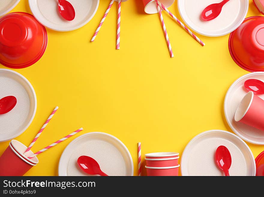 New plastic dishware and space for text on color background. Table setting