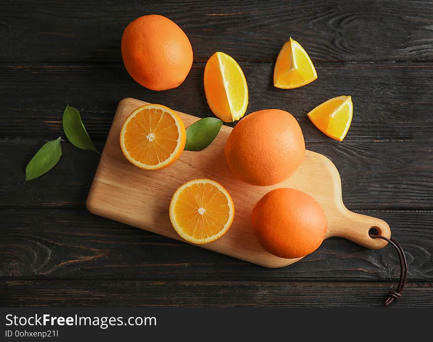 Fresh juicy oranges on wooden table, top view