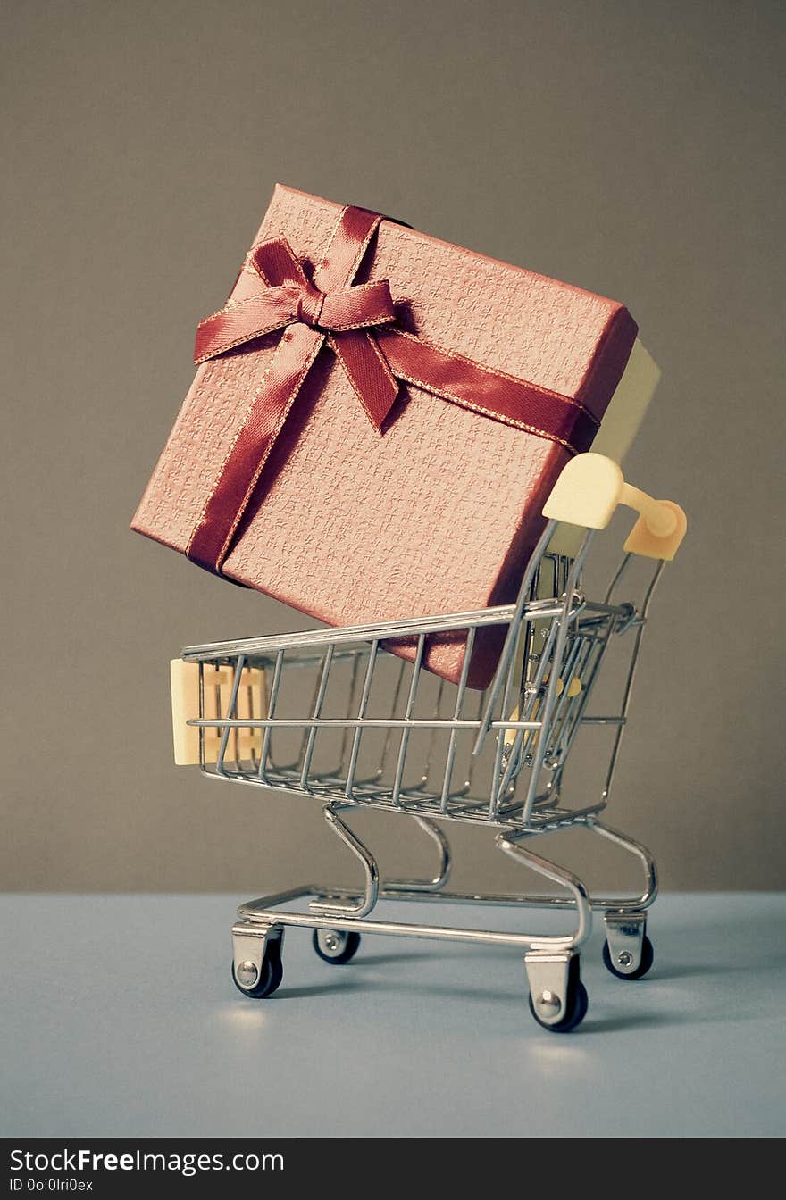 huge red gift box in shopping cart - online shopping