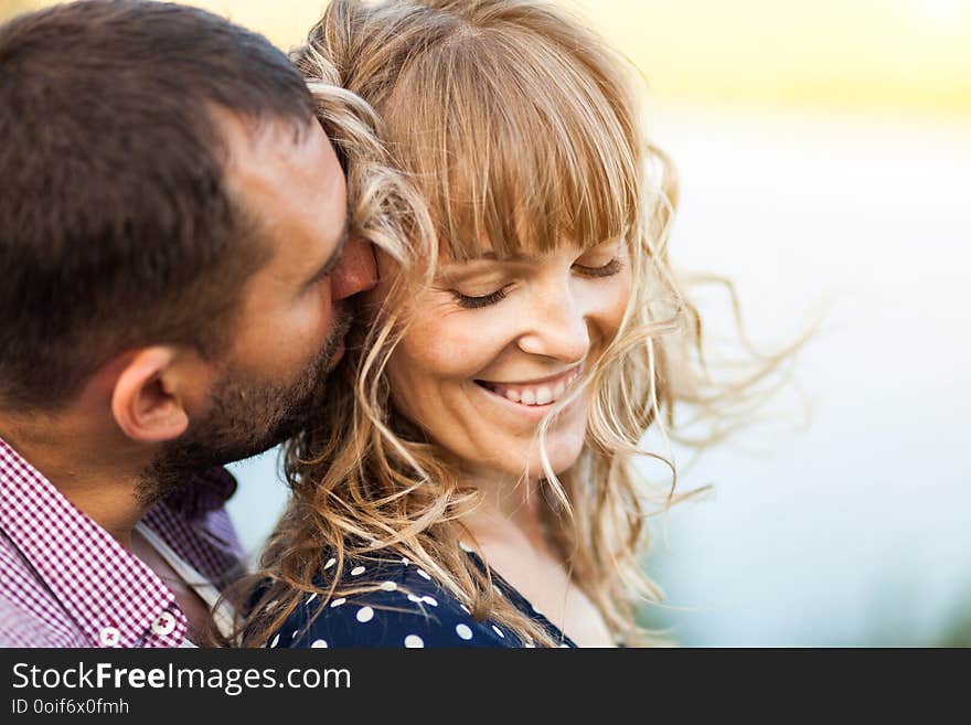 Close-up portrait of couple with wind in hair, hugging and happy together soft focus. Close-up portrait of couple with wind in hair, hugging and happy together soft focus