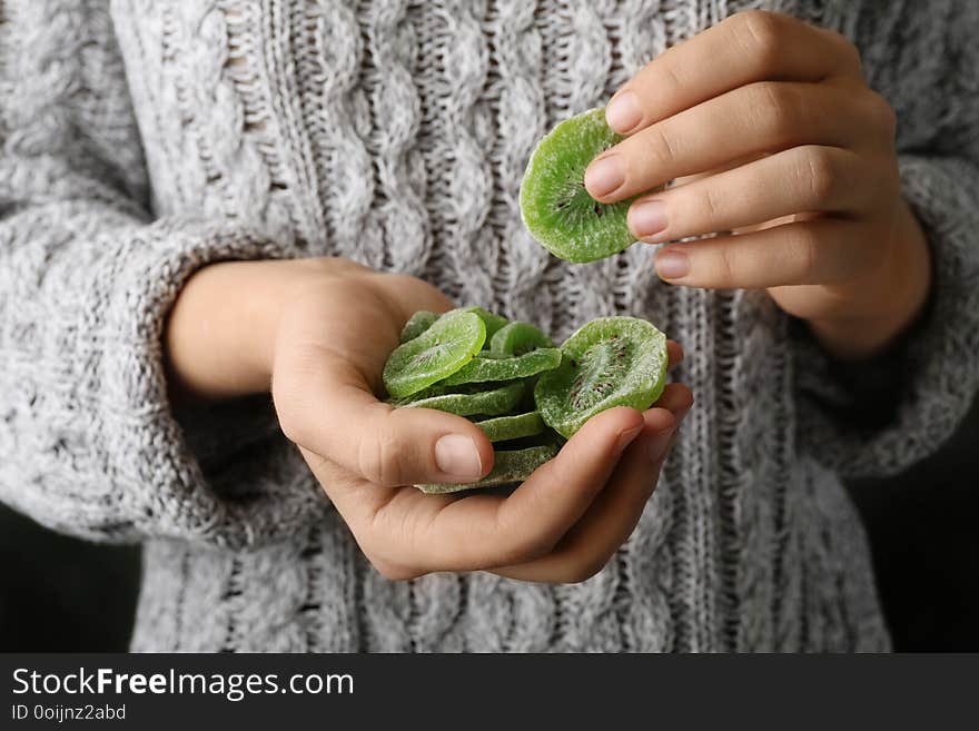 Woman holding handful of tasty kiwi, closeup. Dried fruit as healthy food