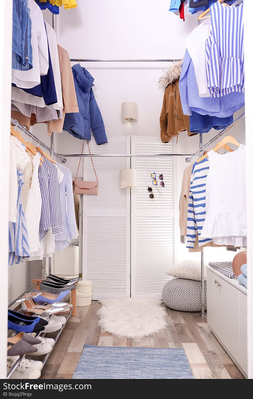 Modern dressing room with different stylish clothes