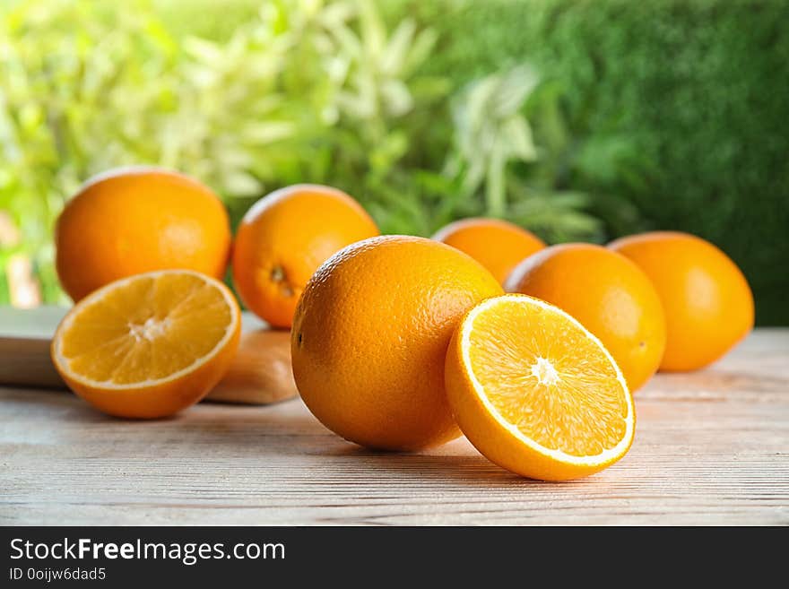 Fresh juicy oranges on wooden table. Healthy fruits