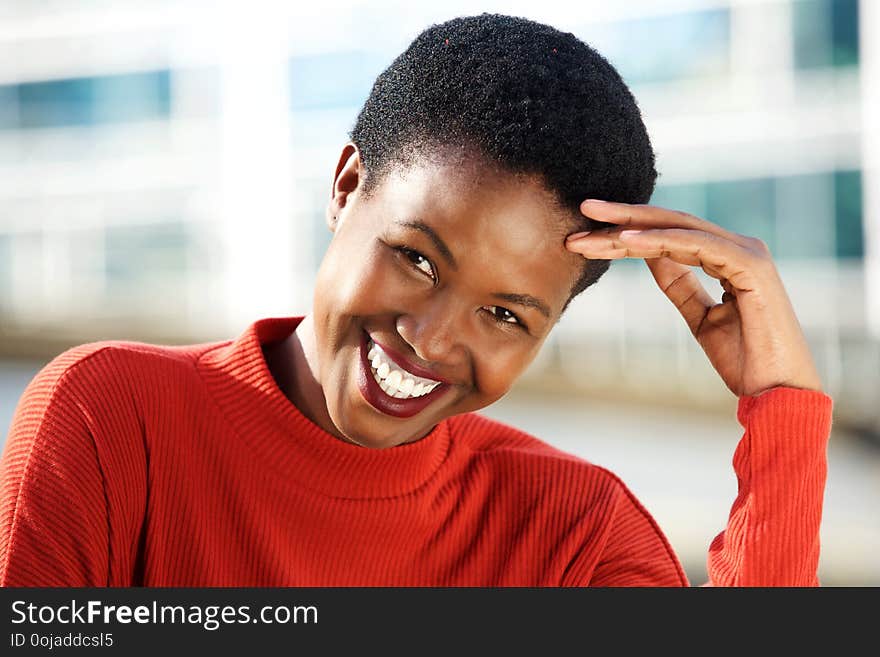 Close up portrait of beautiful young african woman smiling outside. Close up portrait of beautiful young african woman smiling outside