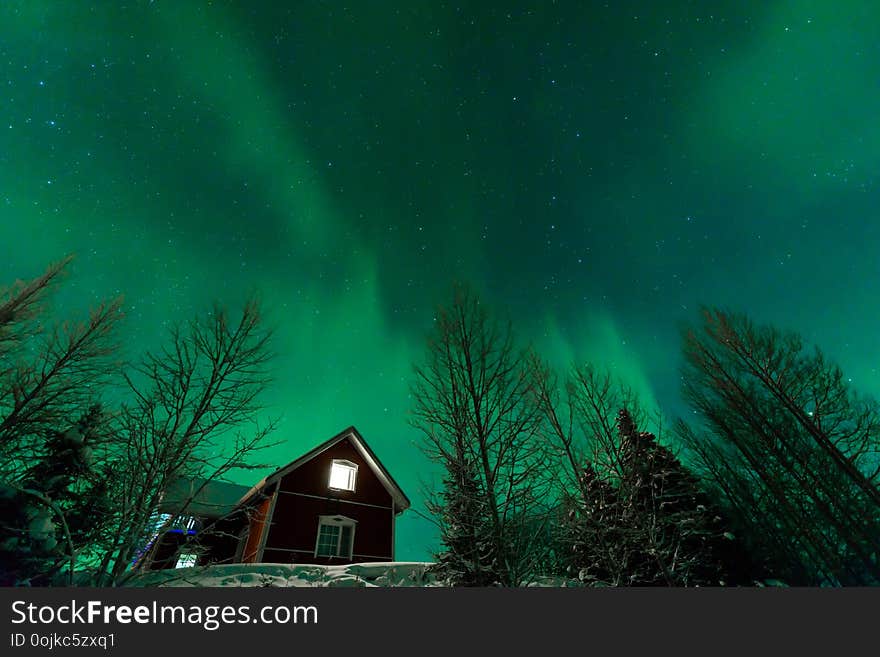 The Northern Lights Aurora Borealis At Kuukiuru Village Lake In Lapland, Finland