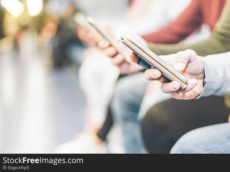 Group of millennial friends watching their smart mobile phones - New generation addicted to new technology trends