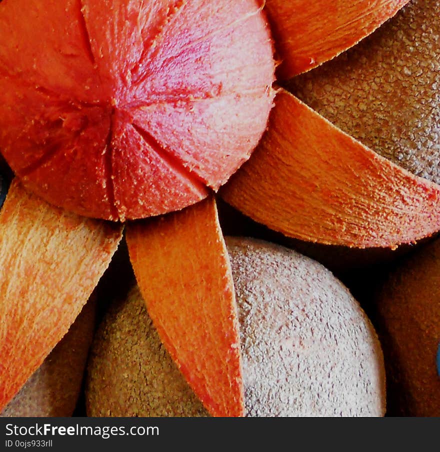 Delicious and beautiful mamey, the skin is brown, oval, there is one open and looks like a flower with the shell like petals and in the center the fruit of the mamey, is on top of other mameys