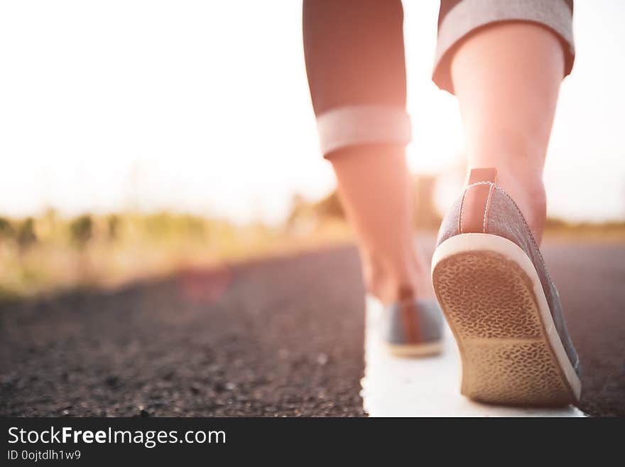 Closeup woman walking towards on the road side. Step concept