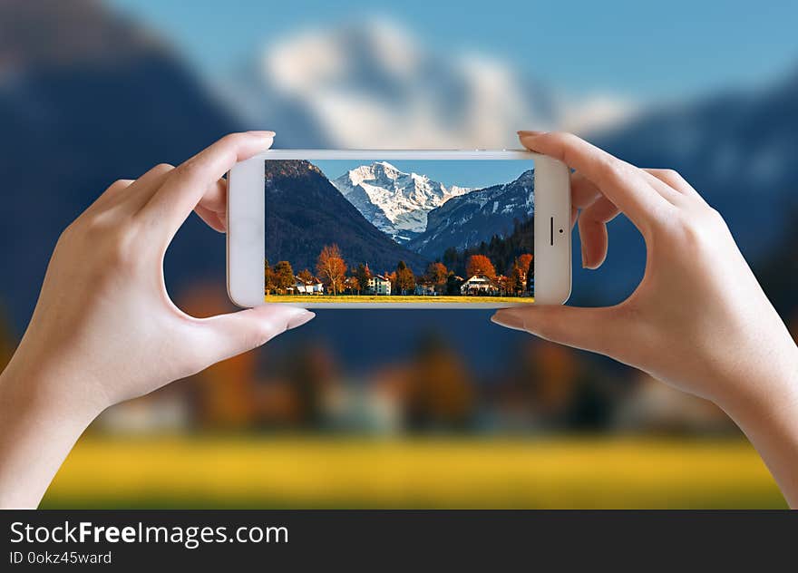 Hands take photo of nice mountain and sky scenery view with mobile