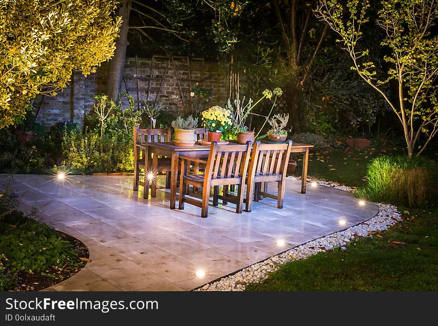 Lovely terrace outside luxury house during the night time. Lovely lights and trees