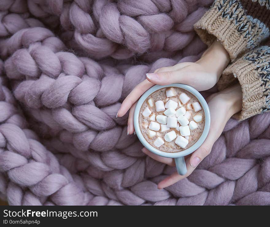 Cozy Hugge rug in the interior, Scandinavian style, Merino wool handmade, Women`s hands and mug of coffee